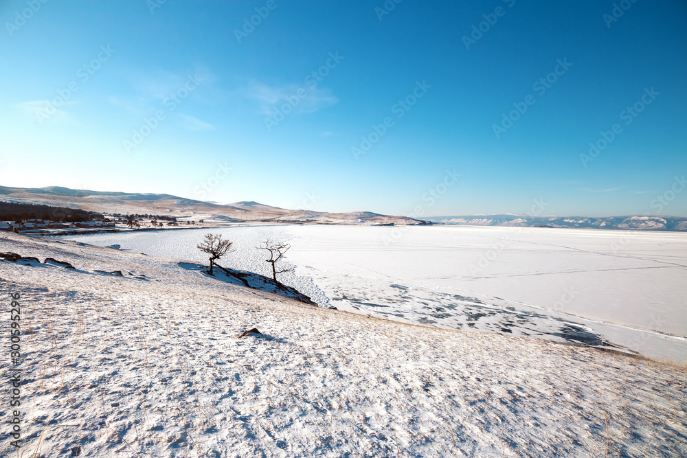 Winter landscape with lake covered with ice.Lake Baikal, Russia Winter landscape with lake covered with ice.Lake Baikal, Russia