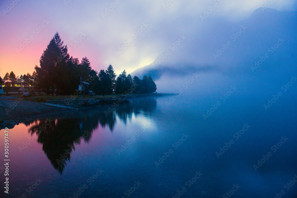 fog over a mountain lake before dawn.
