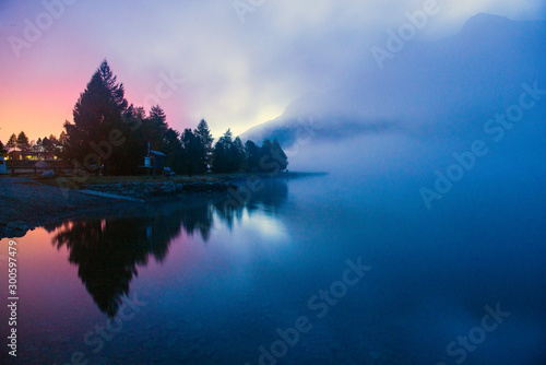 fog over a mountain lake before dawn.