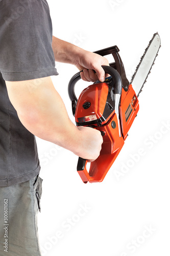 Chainsaw in a male hand isolated on a white background