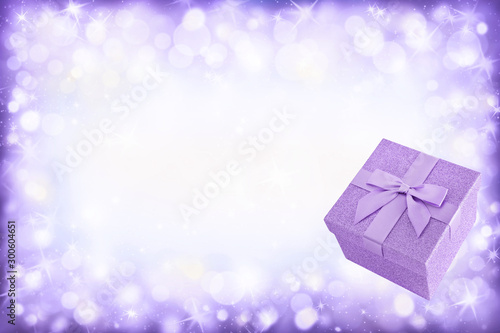 Sparkling background with violet gift box
