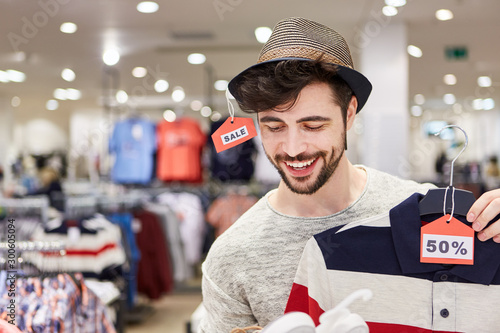 Young man is happy about fashion discount photo