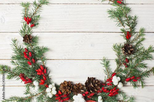 Christmas wreath on white wooden backdrop
