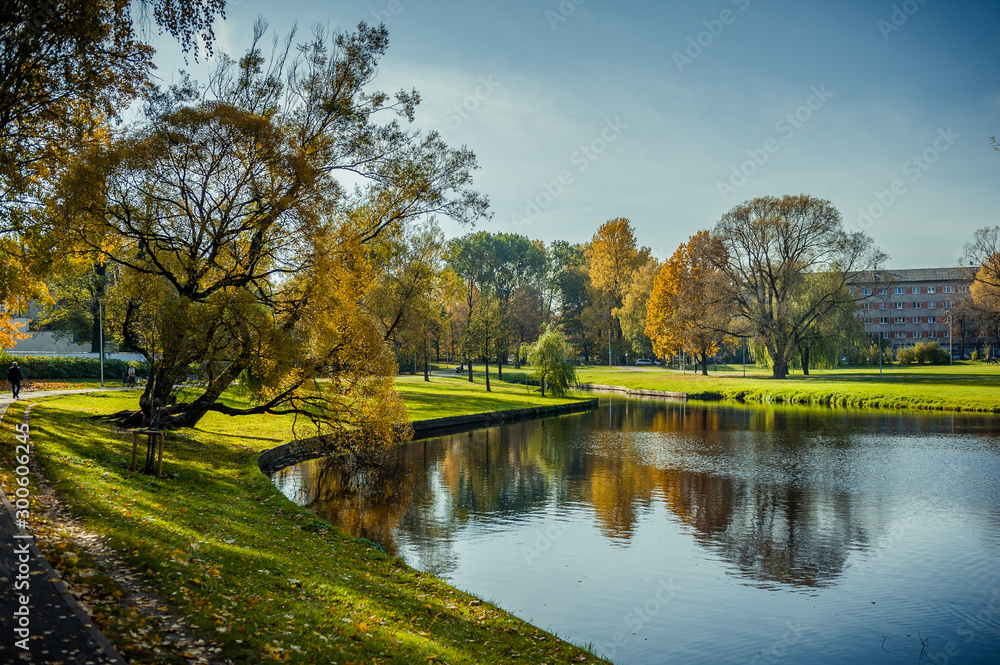 Beautiful autumn scene of Maras Pond in Riga. Autumn cityscape with soft sunlight. Agenskalsns district. Latvia. Beautiful autumn scene of Maras Pond in Riga. Autumn cityscape with soft sunlight. Agenskalsns district. Latvia.
