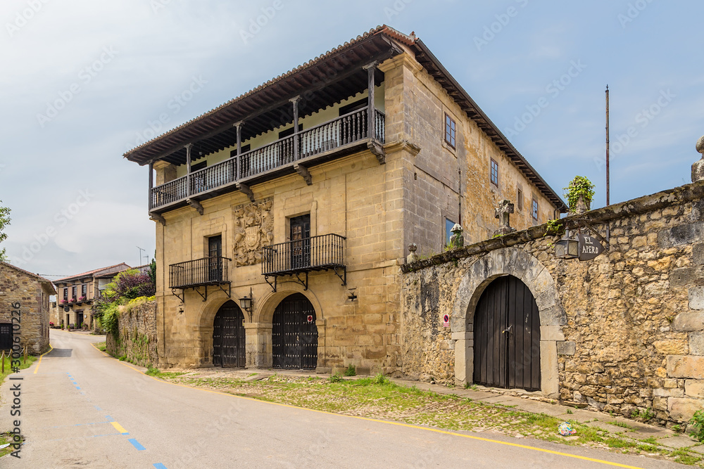 Santillana del Mar, Spain. An old mansion with the coat of arms on the facade on the street Revolgo
