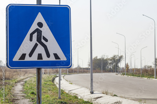 Pedestrian crossing road sign near the road