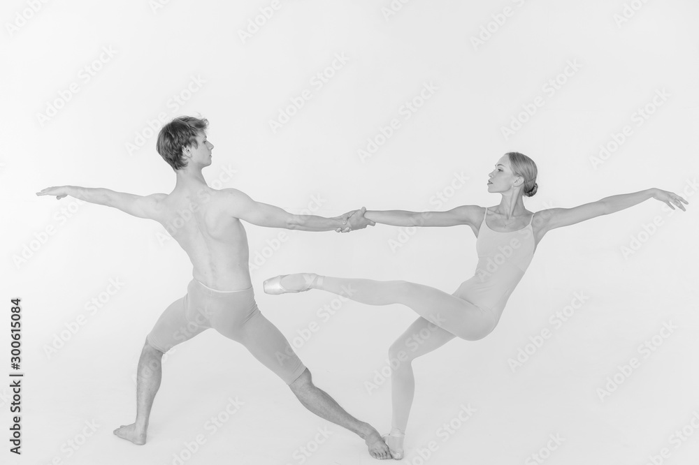 Two young classic ballet dancers practicing against white studio background Two young classic ballet dancers practicing against white studio background