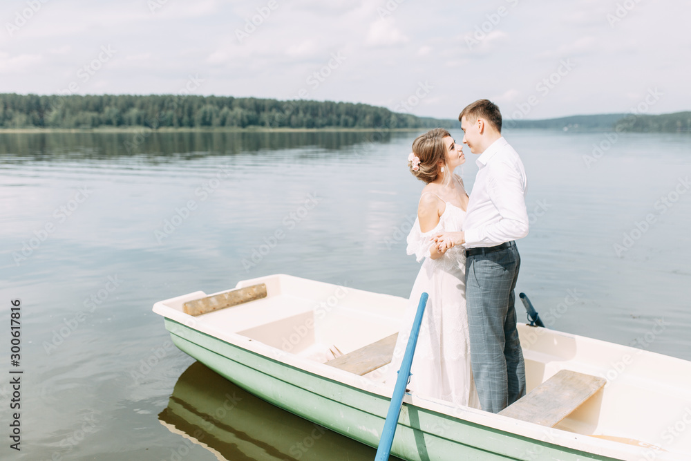 Stylish wedding in European style. Happy couple on a boat on the lake. Stylish wedding in European style. Happy couple on a boat on the lake.