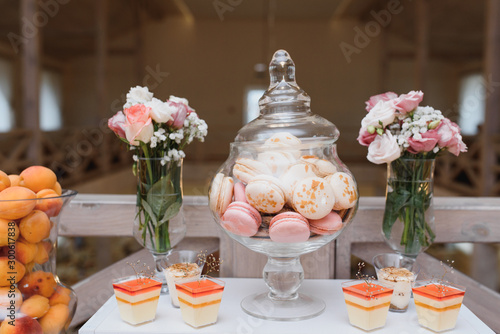 desserts with fruits, mousse, biscuits. Different types of sweet pastries, small colorful sweet cakes, macaron, and other desserts in the sweet buffet