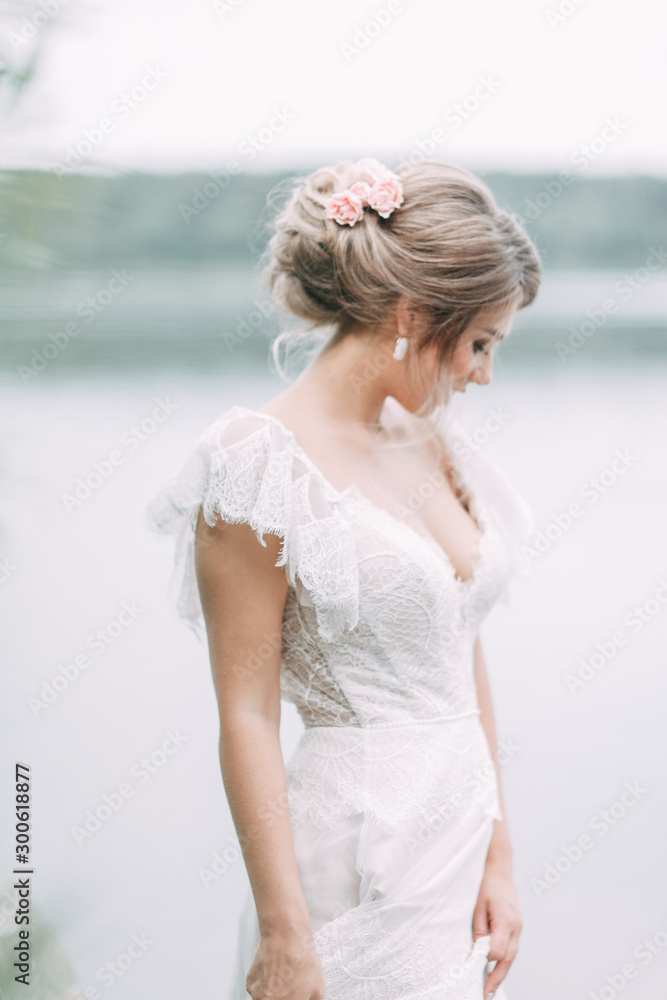 Wedding dress in European style. Happy bride at sunset on the lake. Wedding dress in European style. Happy bride at sunset on the lake.