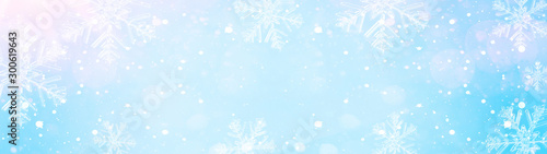snowflakes and ice crystals isolated on blue sky - winter background panorama banner long