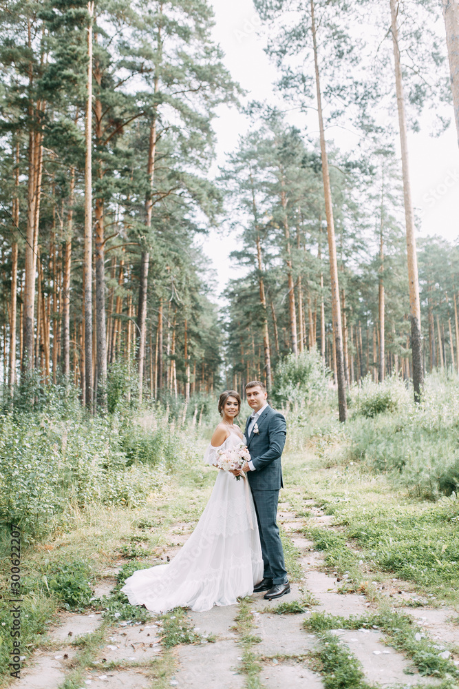 Modern ceremony in European style. Beautiful wedding couple in atmospheric forest with rocks. Modern ceremony in European style. Beautiful wedding couple in atmospheric forest with rocks.