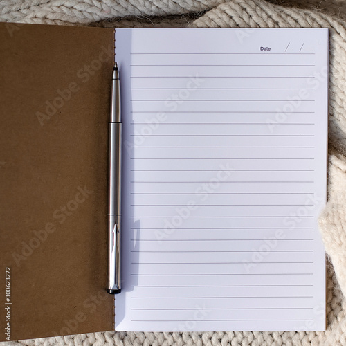 Wallpaper Mural Diary or notebook, pen on white knitted background. Flat lay, to Torontodigital.ca