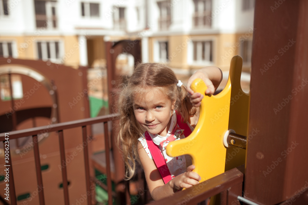 Happy girl plays in the playground, outdoor, summer Happy girl plays in the playground, outdoor, summer