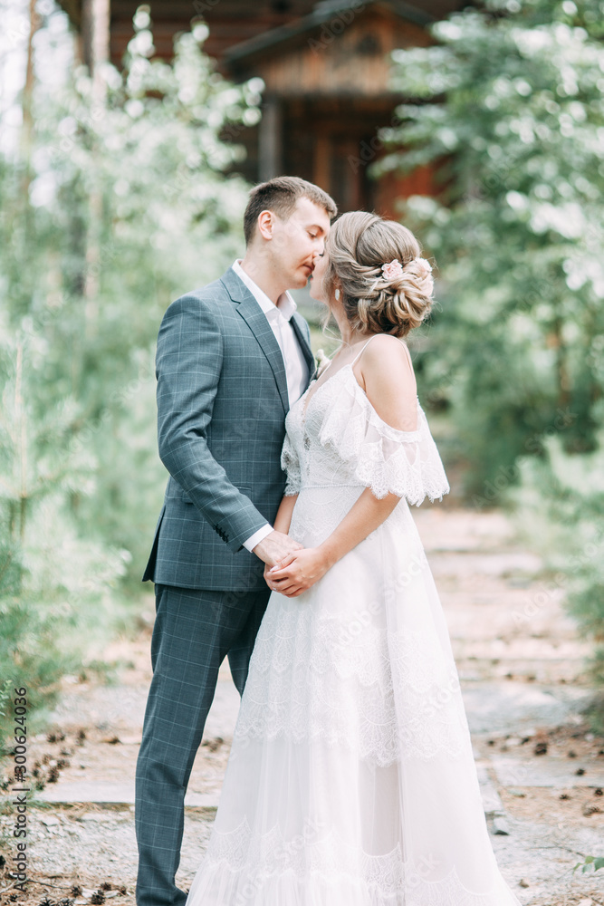 Stylish couple on the background of a wooden temple. Wedding in nature in the woods. Stylish couple on the background of a wooden temple. Wedding in nature in the woods.