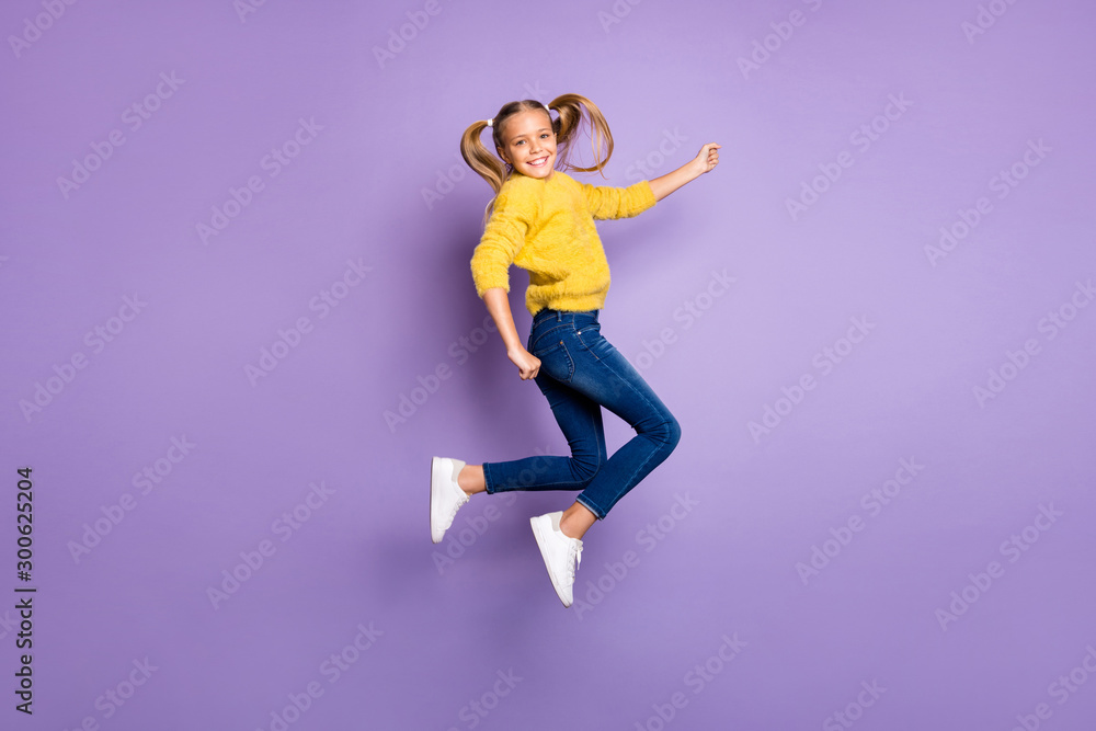 Fototapeta premium Full length photo of cheerful candid child jump enjoy fall weekends wear casual style outfit isolated over purple color background