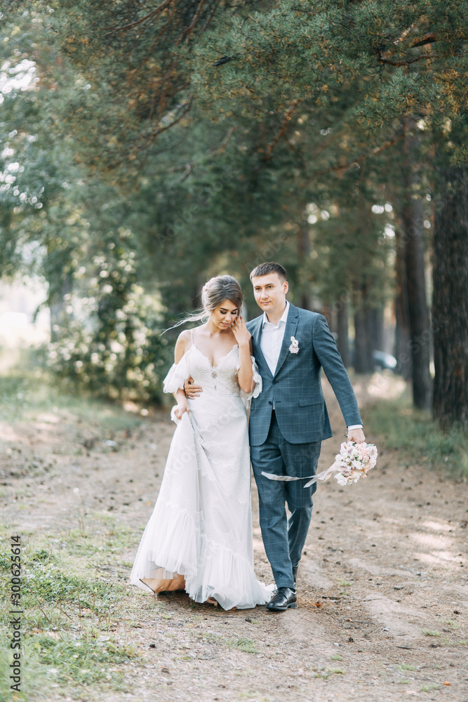 Stylish European wedding at sunset. Happy couple in the forest in nature. Stylish European wedding at sunset. Happy couple in the forest in nature.