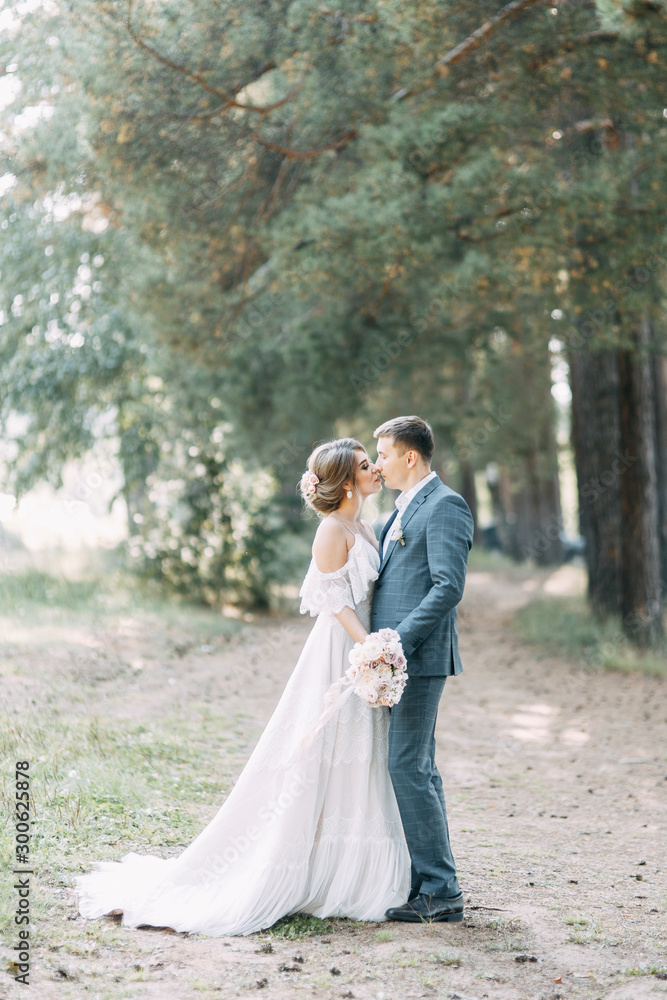 Stylish European wedding at sunset. Happy couple in the forest in nature. Stylish European wedding at sunset. Happy couple in the forest in nature.