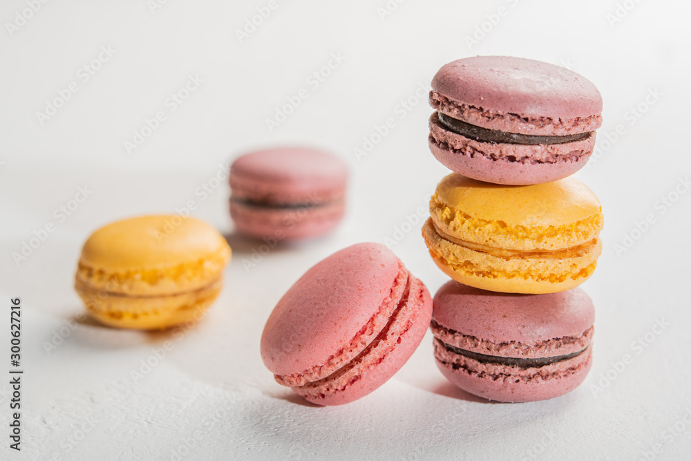 Macarons pattern on white background. Colorful french desserts. Close up