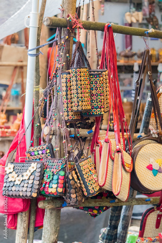 Handcrafted colorful, wallets, purse, bags for ladies, women and kids, serves as a souvenir as well as storage utility, local shop at popular tourist destination, North-East, Shillong, Meghalaya, IND