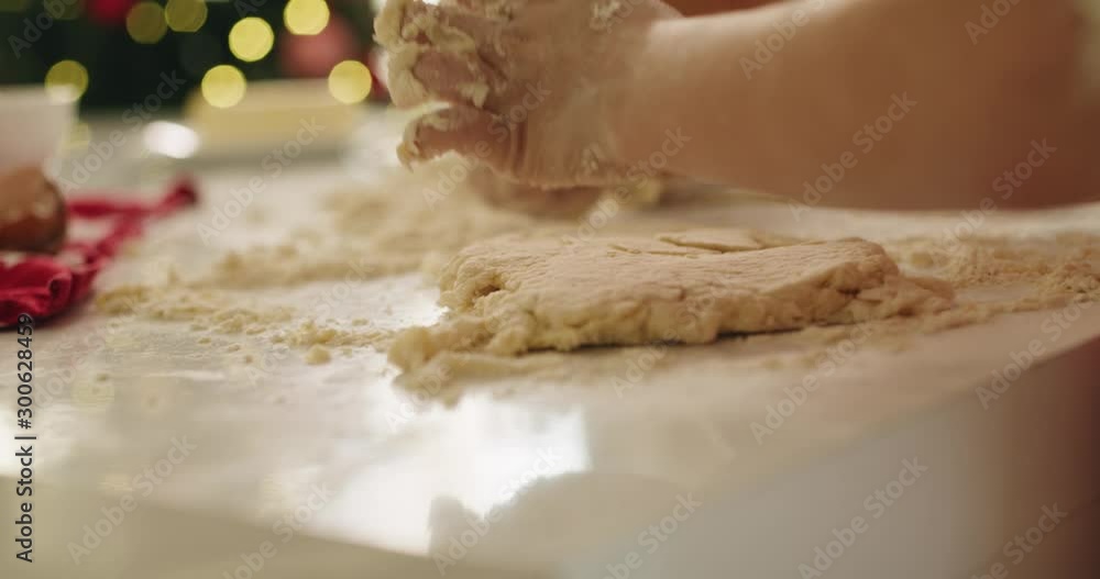 Handheld view of child rolling the dough Handheld view of child rolling the dough