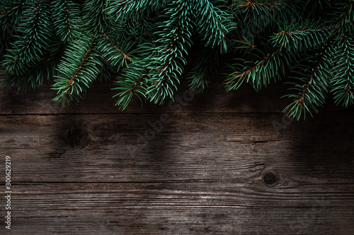 Christmas green frame from fir branches on a vintage gray board background. Frame of fir branches. Christmas card blank.