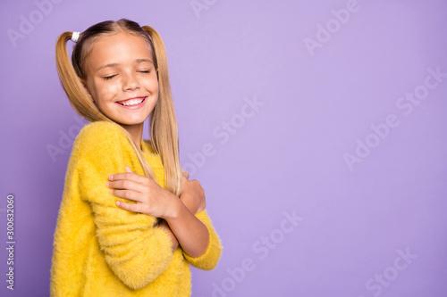 Photo of trendy cheerful toothy beaming girl hugging herself feeling comfortable isolated pastel violet color background photo