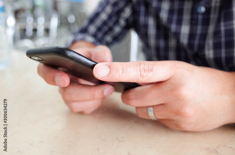 Men hands using smartphone at cafe. man typing an message. Men hands using smartphone at cafe. man typing an message.