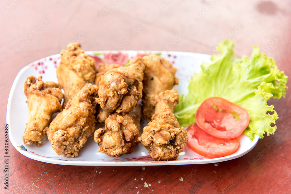 Fried chicken with vegetables and slide of tomatoes Fried chicken with vegetables and slide of tomatoes