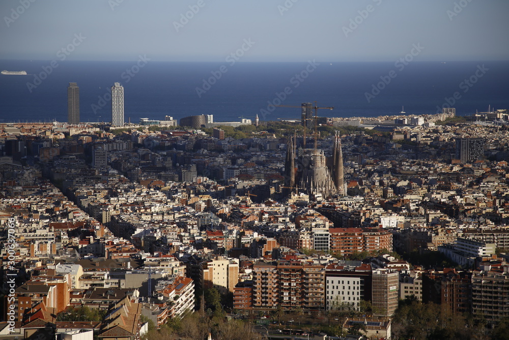 Barcelona, Catalonia / Spain »; December 2017: Aerial view of the city of Barcelona and the holy family under construction on a cloudy winter afternoon