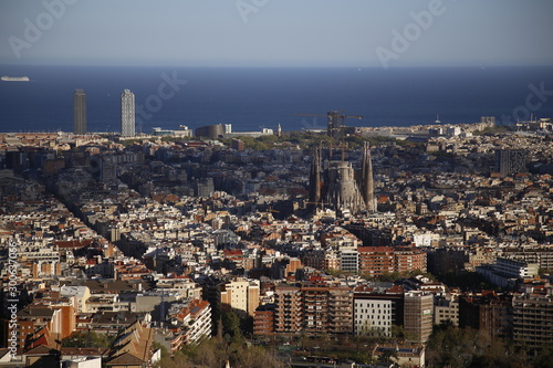 Barcelona, Catalonia / Spain »; December 2017: Aerial view of the city of Barcelona and the holy family under construction on a cloudy winter afternoon