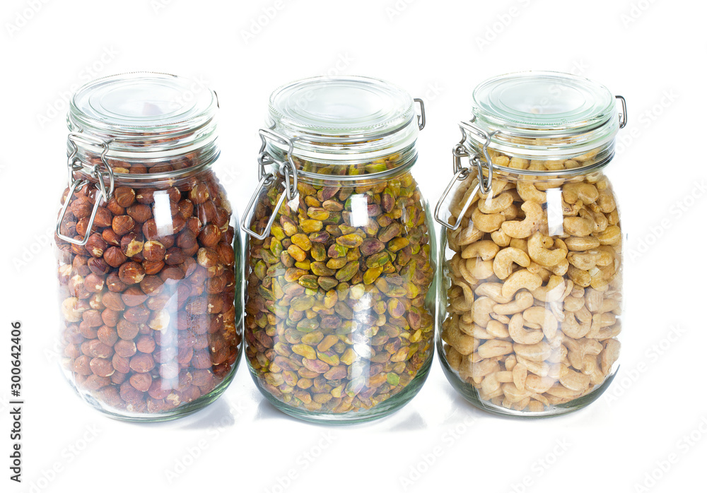 nuts in glass jars isolated on white nuts in glass jars isolated on white