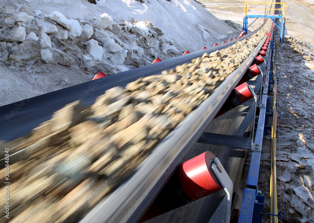 Conveyor belt moves ore from the quarry for processing - obrazy, fototapety, plakaty 