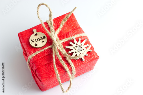 Christmas composition. Red Gifts box, wooden Christmas  decorations on white background. Christmas, winter, new year concept. Flat lay, top view, copy space