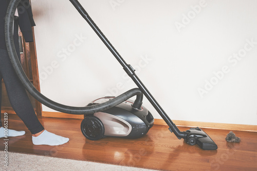 Cleaning the floor with vacum cleaner. photo
