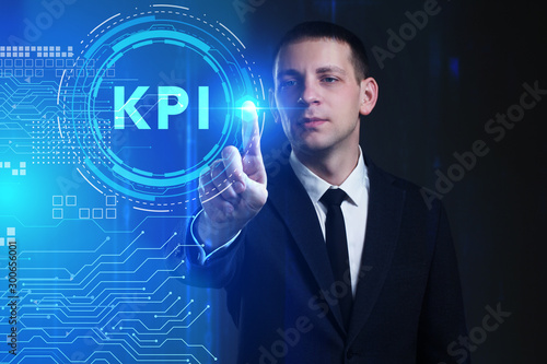 Business, Technology, Internet and network concept. Young businessman working on a virtual screen of the future and sees the inscription: KPI