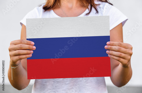 woman holds flag of Russia on paper sheet