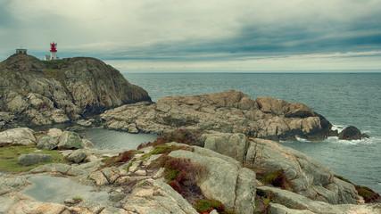 Leinwandbilder Khaki Norway landscape south lighthouse Lindesnes fyr on the rocky shore of the northern sea in cloudy weather  © Lana Kray