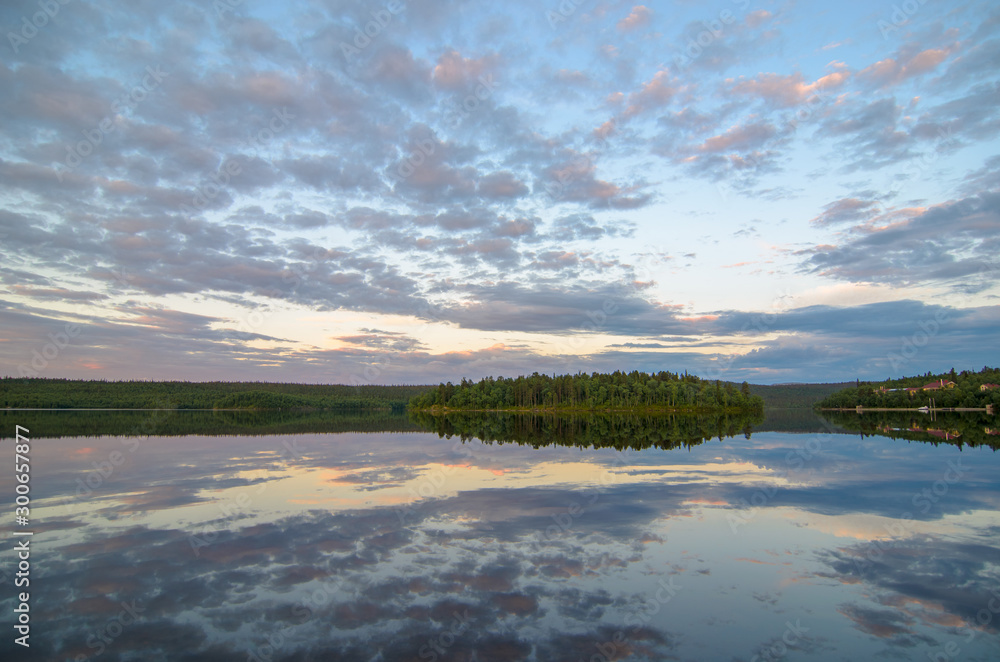 Fototapeta premium Dramatic summer sunset and pines at Tuloma river, Kola Peninsula, Murmansk region, Russia