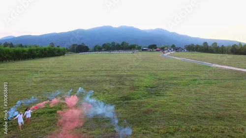 Lovers hand in hand with colored fireworks