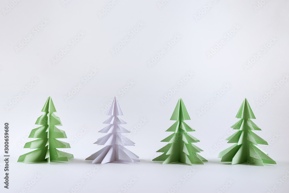 Christmas concept. Origami paper green Christmas trees. - obrazy, fototapety, plakaty 