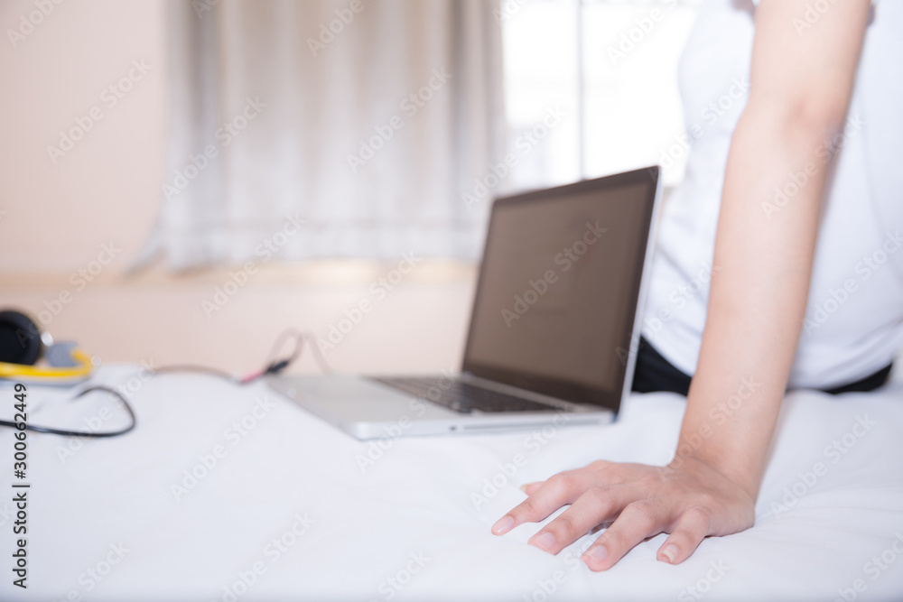 Women in sporty pajamas sit or chat online with friends or shopping online. And relax in bed on holiday. Women in sporty pajamas sit or chat online with friends or shopping online. And relax in bed on holiday.
