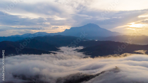 Rural landscape with dramatic sea of cloud during sunrise with Mount Kinabalu at Saba, Borneo © alenthien
