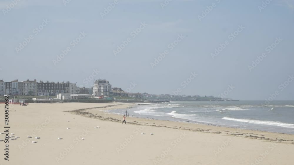 Margate beach with people walking by the sea Margate beach with people walking by the sea