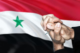 Syria flag and praying patriot man with crossed hands. Holding cross, hoping and wishing.