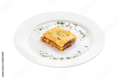 Piece of homemade Lasagne with beef isolated on white background