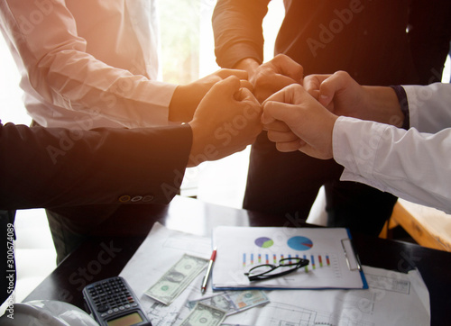 Teamwork Join Hands Support Together Collaboration Concept.Young Asian business people show symbolic hand for promised purpose to achieve the goal.