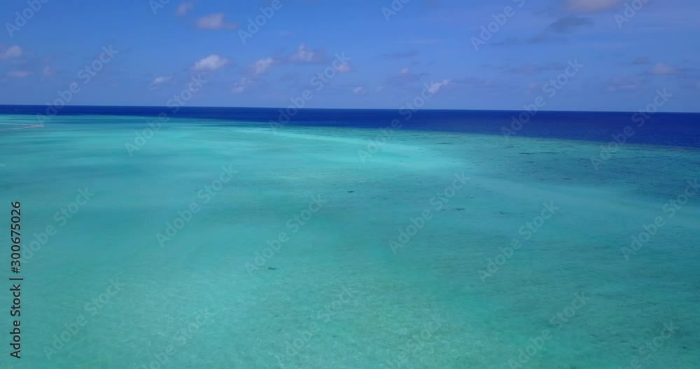Blue ocean with transparent water and clouds in the sky - Wide shot Blue ocean with transparent water and clouds in the sky - Wide shot