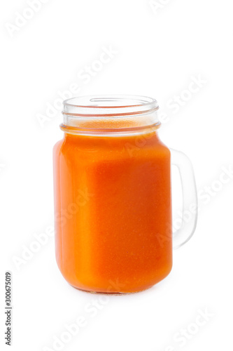 Closeup glass jar of carrot juice isolated at white background. Concept of healthy vegan food