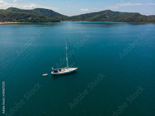 Aerial view of white Yacht in deep blue sea with beautiful landscape view in Kuala Abai, Kota Belud, Sabah, Malaysia © alenthien